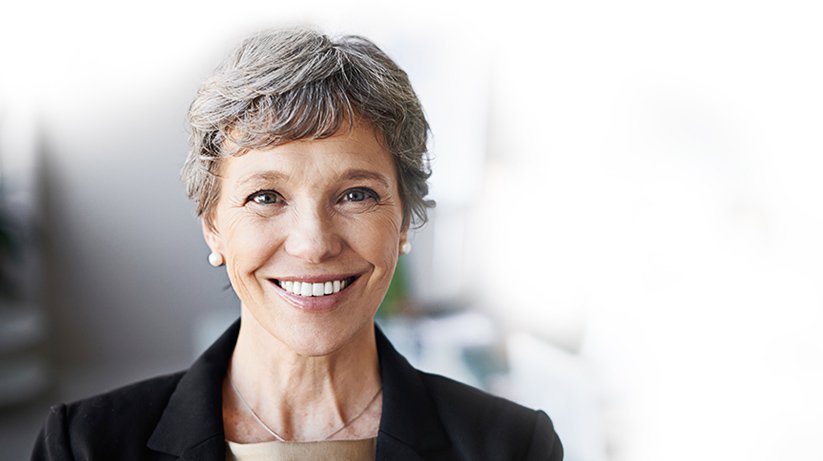 Middle-aged female insurance worker in business attire smiling