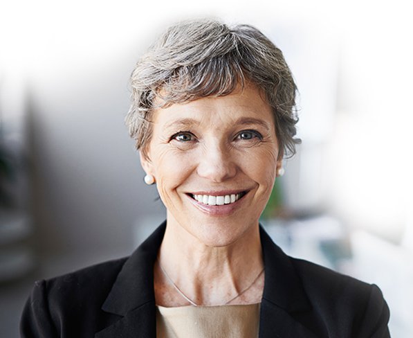 Middle-aged female insurance worker in business attire smiling