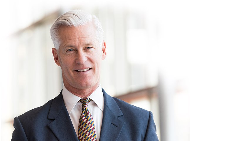 Older male insurance worker smiling